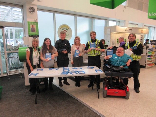 Accessible News volunteers with officers from South Wales Police, Staff from Rhondda Cynon Taff Equalities Team with Julie from Asda