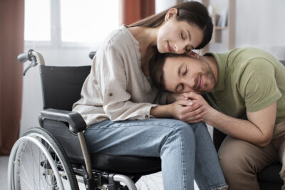 Disabled woman in a wheelchair with non-disabled male partner.